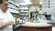 Buddy works on tree figure for snowglobe in bakery.