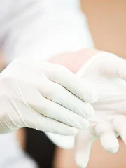 Doctor putting on examination gloves. Taken on iStockalypse Tokyo, Japan.