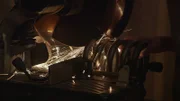 Closeup of contestant cutting coil with circular saw, sparks flying off