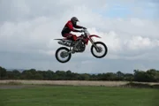 Dunsfold, Guildford, Surrey, UK: A motorbike professional performing a jump.