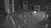 LONDON - Dan Magness is attempting to dribble a ball around a series of cones to a goal in the complete dark. He can’t see anything in the room and shoots in the wrong direction.