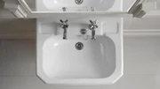 Washbasin in front of bathroom mirror.
