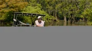 Richard Campanella on a boat in the Louisiana swamps.