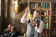 Magician Eric Leclerc during Pear in a Bottle Game, designed to tests participants' logic skills based on whether or not they can figure out how the pear got inside a glass bottle.