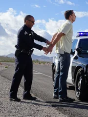 Las Vegas, NV - Sergeant Chris Curtis handcuffs a suspect during Car Thief.  (photo credit:  NGT/Corey Surratt)