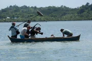 SULAWESI - Großaufnahme der Crew auf dem Boot, die Hazen bei der Suche nach Seeigeln filmt.