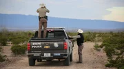 Police truck with Warden standing next to it.