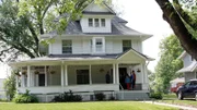 Fry family meet with realtor Ethan on front porch of house 2