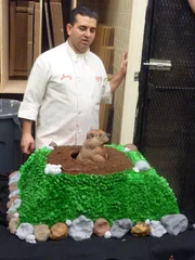 Buddy with Groundhog Cake in bakery.