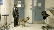 Officer Romero waits outside of the pat down room with her K9. (National Geographic)