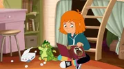 Lilli sucht in einem alten Buch nach Hilfe gegen Schluckauf.