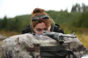 PORT PROTECTION, ALASKA- Amanda Makar sights her rifle in before her deer hunt. (Photo Credit: National Geographic Channels/ Rocco Colonna)