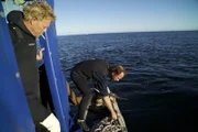 Captain Scott monitors greenhorn Steve Riedel as he drops anchor.