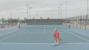 Jess isn't very good at serving and shows us that when she serves from her knees she is more likely to get the ball in.