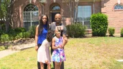 The family taking a selfie in front of their new house