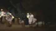 The police holding a gun at the zoo at night.