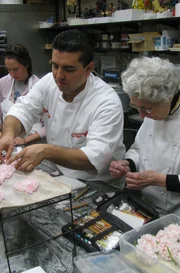 Betty & Buddy make flowers for cake.
