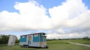 Sarah and Abby Bontempo's tiny home is a true work of art with a gorgeous, colorful tree mural on the exterior for their yoga and fitness class studio, Thrive, here in Austin, Texas, as seen on Tiny House, Big Living.