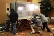 The gang pushing acrylic tank into the wall.