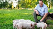 Ludger Bremehr bei den Ferkeln auf der Weide. Weiteres Bildmaterial finden Sie unter www.br-foto.de.