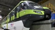 Close up of monorail train from below, in waiting bay.