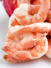 Frozen peeled shrimps on white background