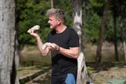 Rewa, Guyana - Gordon Ramsay holding caiman tail during the big cook. (Credit: National Geographic/Justin Mandel)