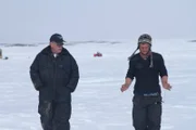 Steve Pomrenke shows Zeke Tenhoff how to use dowsing rods.