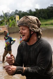 West Sumatra, Indonesia - Gordon Ramsay wet and covered in mud after participating in a a bull run called Pacu Jawi. (National Geographic/Jon Kroll)