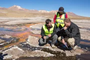 EL TATIO GEYSER FIELD, ATACAMA DESERT, CHILE, MAY 5 2017: Unknown host Josh Gates and scientist Carolina Munoz-Saez (PHD Earth & Planetary Science, currently at the University of Chile) and J.R Stok (PHD Geological Sciences, Mars Geologist, SETI Institute) discuss the silimarities between earth and Mars' geysers in El Tatio Geyser field in the Chilean Andes in the Atacama desert, the driest non-polar desert in the world, whose soil has been compared to that of Mars, owing to its otherworldly appearance, but also because bacteries and rocks at El Tatio are believed to be similar to the ones in Mars' old geysers, prompting scientist to study them in order to better understand Mars' geology and plan future missions to the red planet. El Tatio geyser field is located at 4,320 meters (14,400 feet) in the Andes Mountains of northern Chile. Its name comes from the Quechua word for oven. It is among the highest-elevation geyser fields in the world. El Tatio has over 80 active geysers, making it the largest geyser field in the southern hemisphere and the third largest in the world. EL TATIO GEYSER FIELD, ATACAMA DESERT, CHILE, MAY 5 2017: Unknown host Josh Gates and scientist Carolina Munoz-Saez (PHD Earth & Planetary Science, currently at the University of Chile) and J.R Stok (PHD Geological Sciences, Mars Geologist, SETI Institute) discuss the silimarities between earth and Mars' geysers in El Tatio Geyser field in the Chilean Andes in the Atacama desert, the driest non-polar desert in the world, whose soil has been compared to that of Mars, owing to its otherworldly appearance, but also because bacteries and rocks at El Tatio are believed to be similar to the ones in Mars' old geysers, prompting scientist to study them in order to better understand Mars' geology and plan future missions to the red planet. El Tatio geyser field is located at 4,320 meters (14,400 feet) in the Andes Mountains of northern Chile. Its name comes from the Quechua word for oven. It is among the highest-elevation geyser fields in the world. El Tatio has over 80 active geysers, making it the largest geyser field in the southern hemisphere and the third largest in the world.