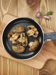 Fried mushrooms in a frying pan.