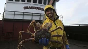 Seabrooke greenhorn Tom Monschein holding crab.