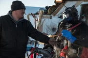 Ricky Larsen checks diver Jesse Strickling's hot water temperature as they prepares for his dive.