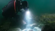 Shawn Pomrenke moves further into a pile of rocks looking for a pay streak.