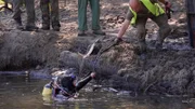 A diver emerges from the swamp.