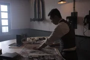 Takeo Yoshikawa sketching a bomb grid on a map of Pearl Harbor.