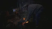 PORT PROTECTION, ALASKA- Curly kocht seine Otterfallen über einem Feuer. (Bildnachweis: National Geographic Channels/Paul Taggart)