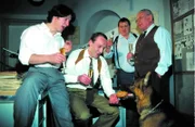 Bei der Abschiedsfeier für Ernst Stockinger (Karl Markovics, 2.v.l.) ist die Stimmung dann doch recht ausgelassen. Stocki traut sich sogar, Rex mit einer Wurstsemmel zu füttern. Kommissar Moser (Tobias Moretti, l.), Peter Höllerer (Wolf Bachofner, 2.v.r.) und Max Koch (Fritz Muliar, r.) freuen sich.