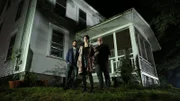 Low angle shot of Shane Pittman (left) Cindy Kaza (center) and Dave Schrader (right) in front of the investigation site in Waterford, ME as seen on Travel Channel's The Holzer Files.