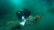 Shawn Pomrenke digs deep under a boulder he flipped, hoping to follow a good pay streak.