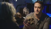 Rob examines wound marks on an ancient skull.