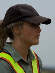 Tyler Mahoney wearing a cap and high viz. Close up