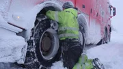 Jan Erik "The Hammer" attaches chains to the rescue truck. They're about to pull an empty truck up a hill and need extra traction in Hardangervidda, Norway.