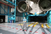 Sean stands in front of the Shuttle