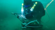 Zeke Tenhoff pours sub-dredge samples into his bucket.