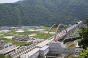 The maglev speeds across a bridge in Tokyo, Japan