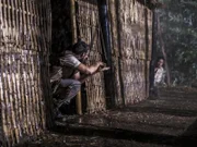 Klusmann meets a fellow POW, a Laotian called Buon Mi. Through sign language, they formulate a plan to escape together.