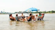 Eine Gruppe junger Menschen sucht im heißen Kölner Sommer Abkühlung im Rhein.