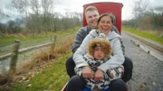 Shaun, Christine and their child, Christian on a train ride in the UK