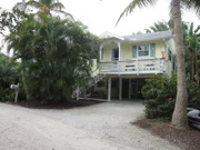A looks at the exterior of a side by side duplex, as seen on House Hunters in Sanibel Island, Florida.
